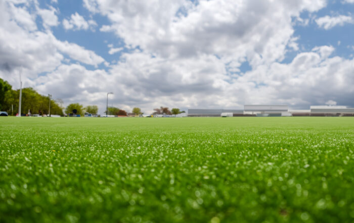 "Well-maintained football field showcasing healthy turf and even surface, highlighting the importance of proper athletic field management for safety and peak performance."